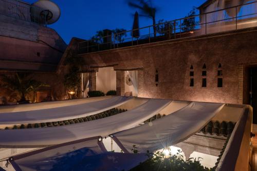 a row of white tents on the side of a building at Riad Altair in Marrakech