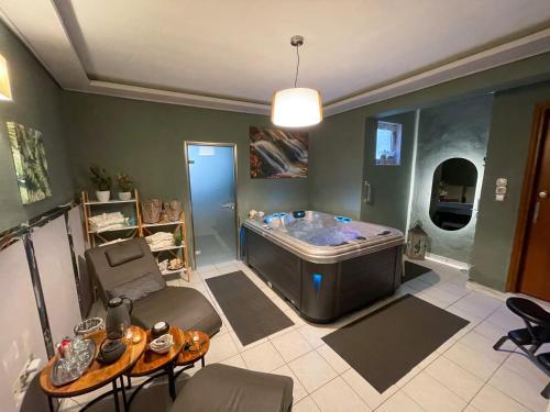 a living room with a large tub in the middle at Philoxenia Inn in Limenas