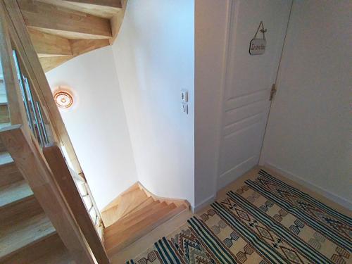 a room with a staircase and a door and a rug at Dream of Mediterranean house, Jacuzzi, BBQ, Délices ensoleillés in Sartrouville