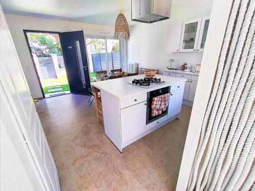 a kitchen with a stove and a counter top at Dream of Mediterranean house, Jacuzzi, BBQ, Délices ensoleillés in Sartrouville