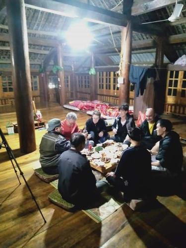 a group of people sitting around a table at Xuân nghi homestay in Yen Bai