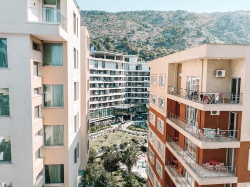 an aerial view of buildings with mountains in the background at Cozy and spacious two bedroom apartment in Shengjin in Shëngjin