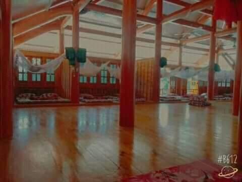 an empty gym with a wooden floor and pillars at Xuân nghi homestay in Yen Bai
