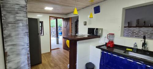a kitchen with a sink and a counter top at Casa Paúba 80m do Mar in Maresias