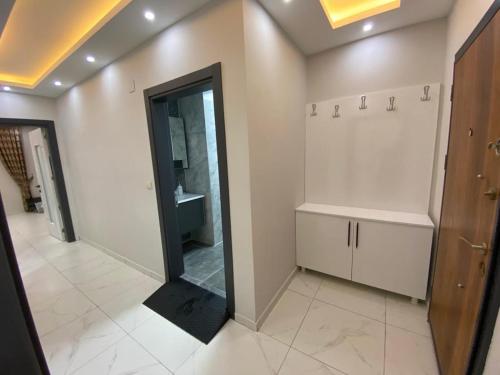 a bathroom with a large mirror and a sink at Brand new 2 bedroom apartment with pool Didim good location in Didim