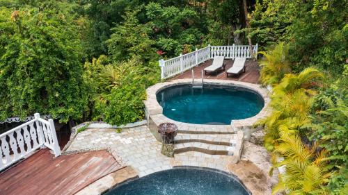 una vista aérea de una piscina con terraza y banco en Fond Doux Eco Resort en Soufrière