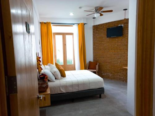 a bedroom with a bed and a window at Santa Cecilia Hotel in Oaxaca City