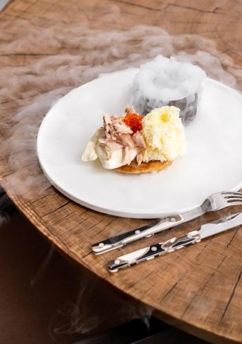 a white plate with a piece of cake on a table at Nosalowy Park Hotel & Spa in Zakopane