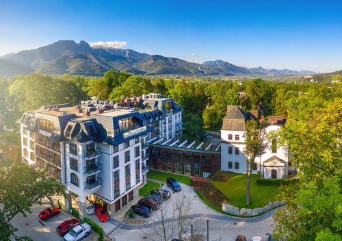 an aerial view of a building with mountains in the background at Nosalowy Park Hotel & Spa in Zakopane