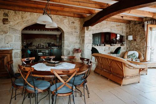 a kitchen and dining room with a wooden table and chairs at Villanath in Bellegarde-sur-Valserine