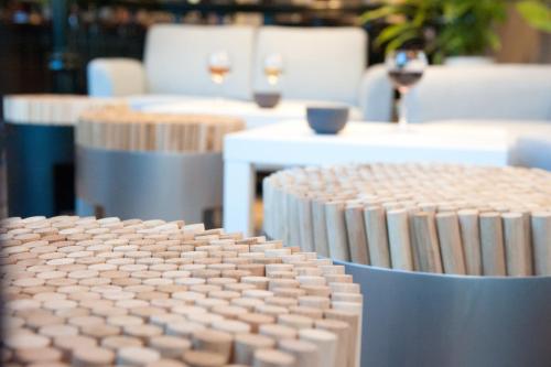a close up of a table with chairs and wine glasses at Ibis Saint Étienne - La Terrasse in Saint-Étienne