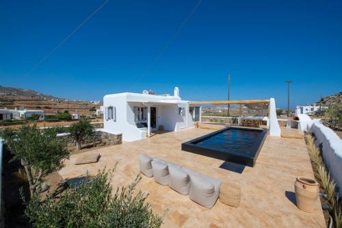 a villa with a swimming pool and a house at Little Villa amid Super Paradise-JackieO' Mykonos in Super Paradise Beach