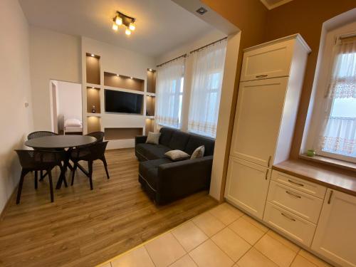 a living room with a couch and a table at Apartament F21B Deluxe w Bielawie Góry Sowie in Bielawa