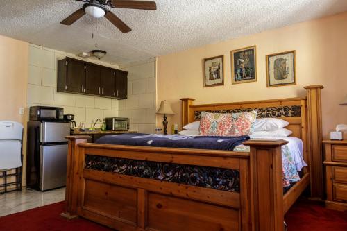 a bedroom with a wooden bed in a kitchen at Playa Hermosa Inn at the beach in Ensenada