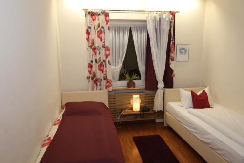 a small room with a bed and a window at Hotel Grader in Neustadt an der Waldnaab