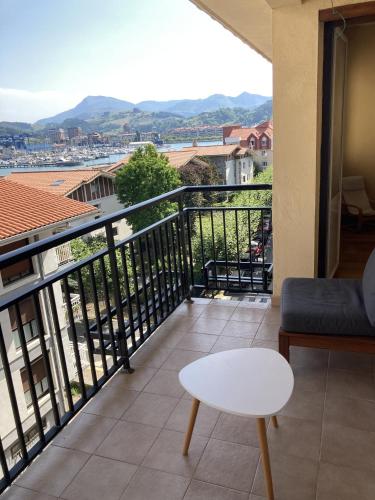 a balcony with a couch and a table and a view at Juan Belmonte ONGI ETORRI in Zumaia