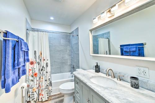 a bathroom with a sink and a toilet and a mirror at Pet-Friendly Fayetteville Home with Fenced Yard in Fayetteville