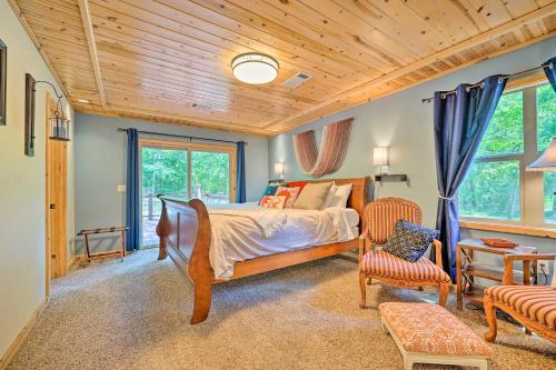 a bedroom with a bed and a chair and windows at Smithville Remote Escape with Furnished Deck! in Smithville