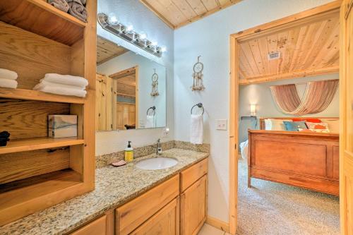 a bathroom with a sink and a mirror at Smithville Remote Escape with Furnished Deck! in Smithville