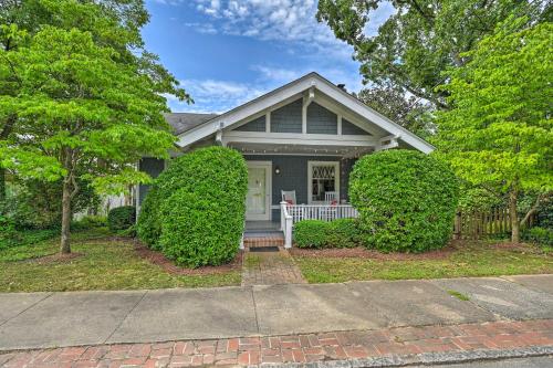 a gray house with a white porch and trees at Bright Greensboro Escape about 1 Mi to Downtown in Greensboro