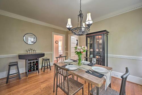 a dining room with a table and chairs and a piano at Bright Greensboro Escape about 1 Mi to Downtown in Greensboro