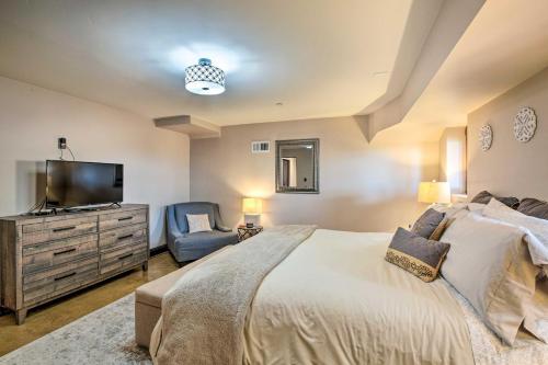 a bedroom with a bed and a tv and a chair at Lovely Belmont Apartment with Stunning Views! in Belmont
