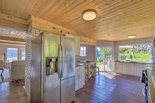 a large kitchen with a stainless steel refrigerator at Waterfront Gig Harbor Home with Furnished Deck in Gig Harbor
