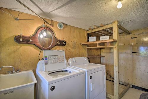 a laundry room with a washing machine and a sink at Waterfront Gig Harbor Home with Furnished Deck in Gig Harbor