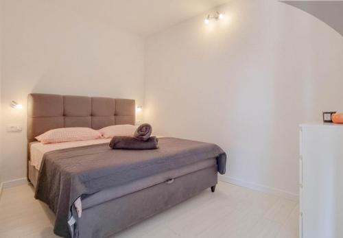 a bedroom with a large bed with a pillow on it at Bella Apartment in Umag