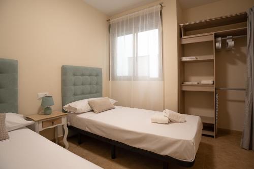 a hospital room with two beds and a window at Nuevo apartamento con A A a 2 minutos de la playa MASBO 2 in Moncófar