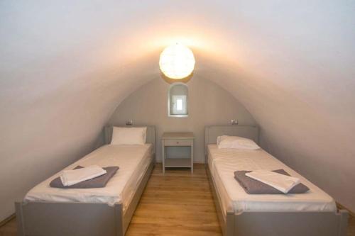 two twin beds in a room with an attic at Kafenes Home in Mesaria