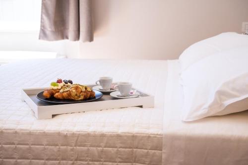 a tray with a plate of food on a bed at ViaNettuno in Civitanova Marche