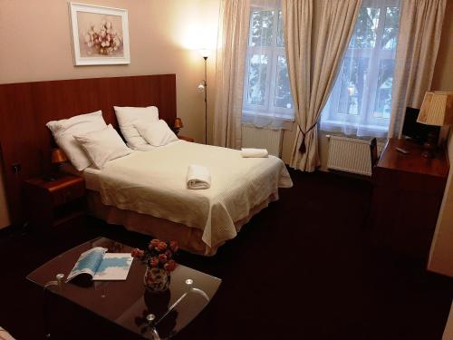a hotel room with a bed and a table at Red Carpet Hostel in Kraków