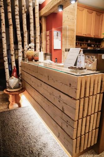 a counter in a kitchen with wooden logs at Sci Sport rooms & suites in Bormio