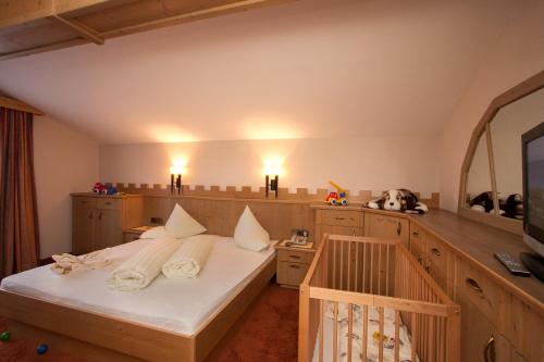 a bedroom with a bed and a large mirror at Kinderhotel Laderhof in Ladis