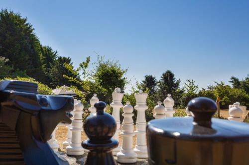 a chess board with a woman playing a game of chess at The Moorland Hotel, Haytor, Devon - The Coaching Inn Group in Haytor