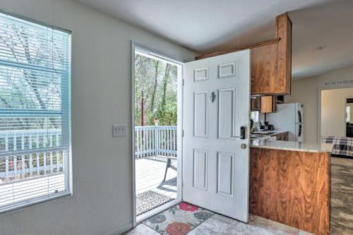 a kitchen with a door leading to a balcony at Quaint Mariposa Home with Private Deck and Yard! in Mariposa