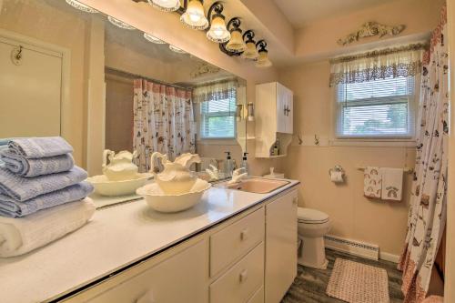 a bathroom with two sinks and a toilet and a mirror at Bright Springfield Home Walk to Nature Center! in Springfield