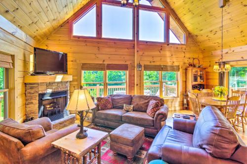 a living room with leather furniture and a fireplace at Tranquil Deck Blue Ridge Mountain Retreat! in Nebo