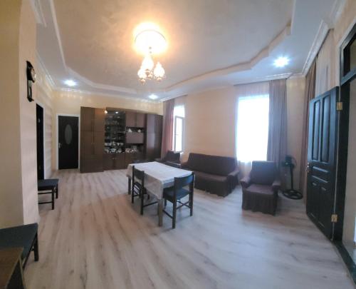 a large living room with a table and chairs at Guest House Sveta in Martvili