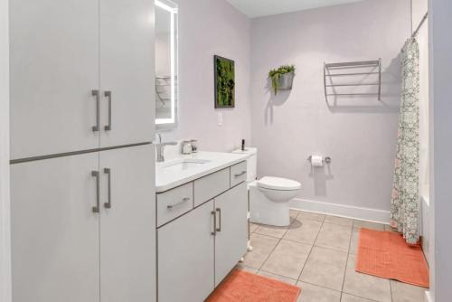 a white bathroom with a sink and a toilet at Nashville 3 Bed, 1 Bedroom with Washer, Dryer and Parking in Nashville