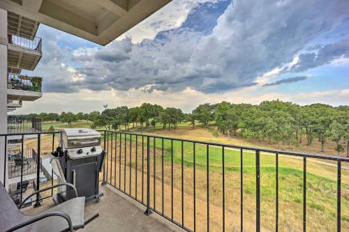 a grill on a balcony with a view of a field at Golf Course and Lake Views Cozy Afton Condo! in Afton