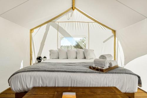 a bedroom with a large bed in a tent at Under Canvas Bryce Canyon in Widtsoe