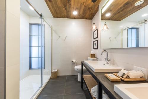 a bathroom with a shower and a sink and a toilet at Espace 4 Saisons in Magog-Orford