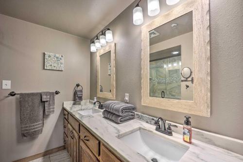 a bathroom with a sink and a large mirror at Cozy Afton Condo with Golf Course and Lake Views! in Afton
