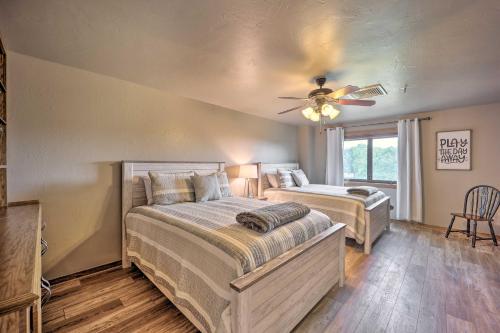 a bedroom with two beds and a ceiling fan at Golf Course and Lake Views Cozy Afton Condo! in Afton