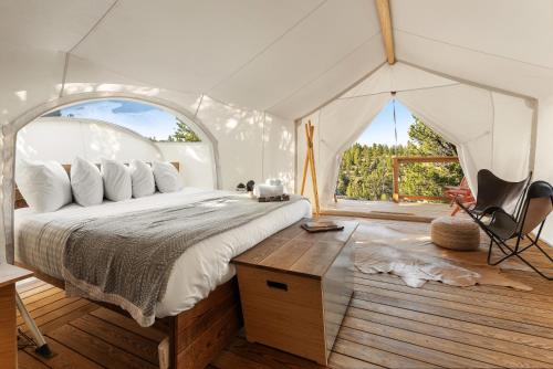 a bedroom with a bed in a tent at Under Canvas Bryce Canyon in Widtsoe