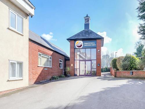 a brick building with a sign on the side of it at Kegworth Hotel & Conference Centre in Castle Donington