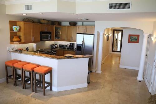 a kitchen with a counter and a refrigerator at Villa Renaissance Grace Bay in The Bight Settlements