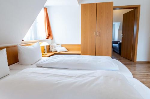 a bedroom with a large white bed in a room at Hotel am Römerplatz in Ulm